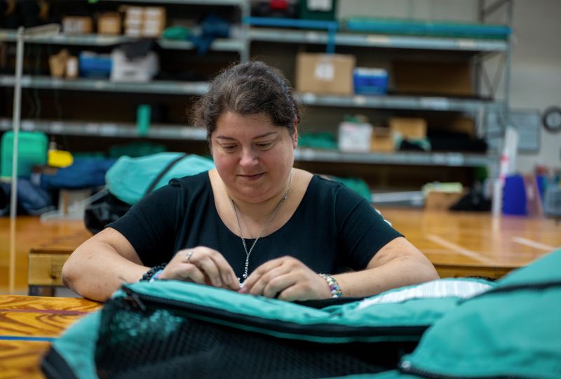 Vivax worker stitching a Soma Safe Enclosure