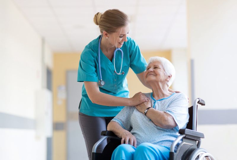 Nurse talking to patient in a wheelchair